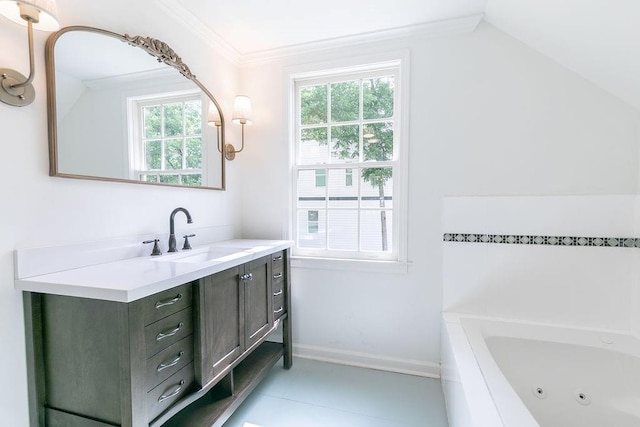 full bath with vanity, ornamental molding, a tub with jets, baseboards, and vaulted ceiling