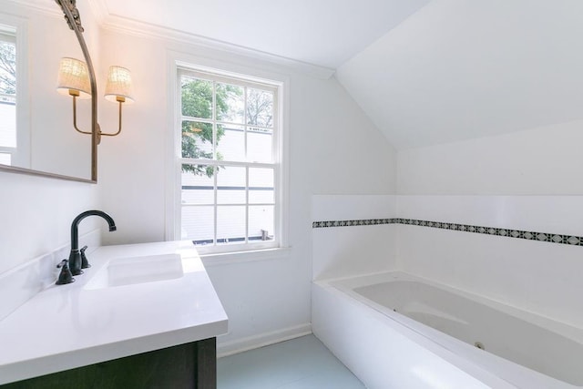 bathroom with a garden tub, baseboards, lofted ceiling, and vanity