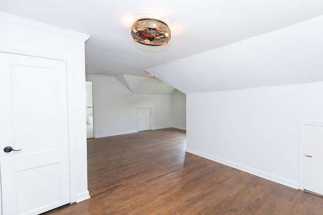 bonus room featuring baseboards, wood finished floors, and lofted ceiling