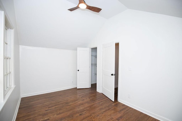 bonus room with a ceiling fan, baseboards, dark wood-style floors, and lofted ceiling