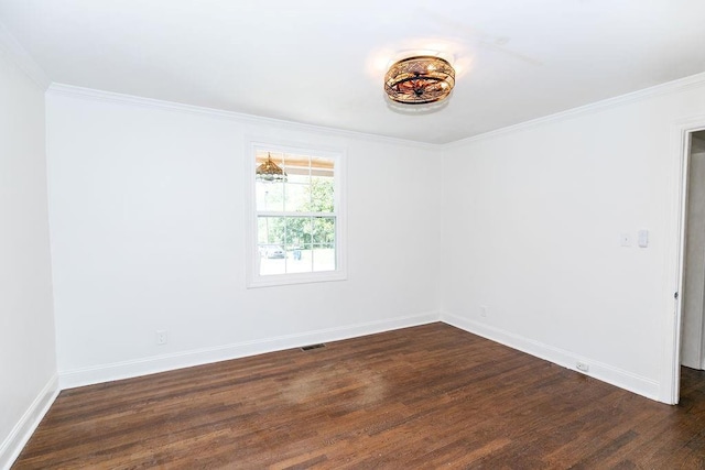 spare room with dark wood-type flooring, baseboards, and crown molding