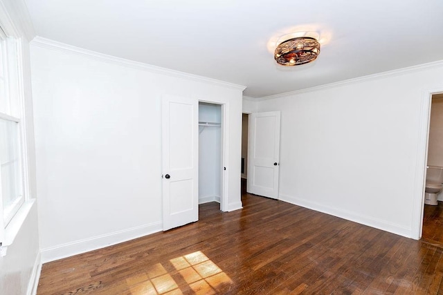unfurnished bedroom with baseboards, ornamental molding, and wood finished floors