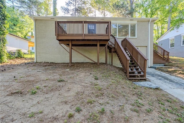 back of property with a wooden deck, stairs, and brick siding
