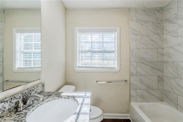 full bath with vanity, baseboards, and toilet