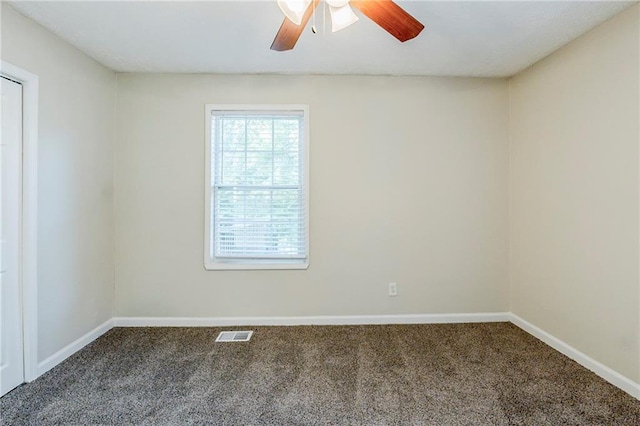 unfurnished room with carpet floors, baseboards, ceiling fan, and visible vents