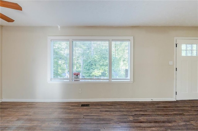 interior space featuring ceiling fan, baseboards, visible vents, and wood finished floors