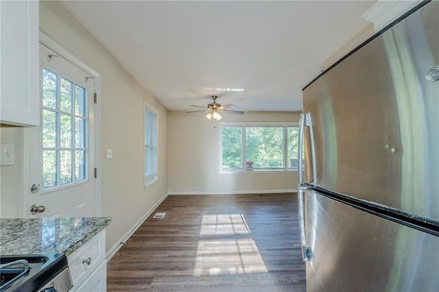 kitchen featuring appliances with stainless steel finishes, dark wood-style floors, and a healthy amount of sunlight