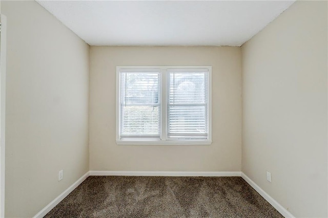 unfurnished room featuring carpet flooring and baseboards