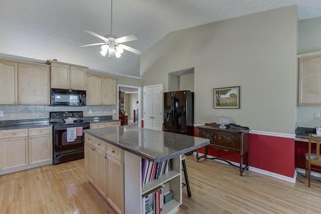 kitchen featuring black appliances, light brown cabinetry, light wood-type flooring, and a kitchen island