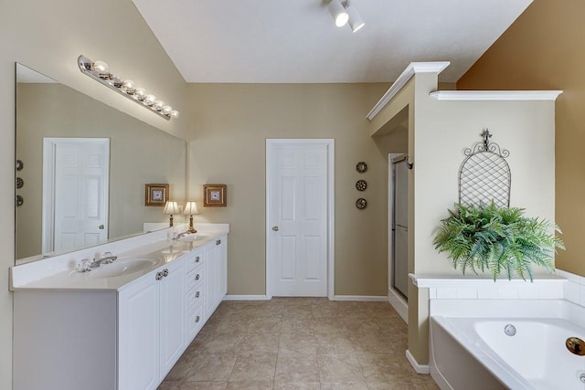 bathroom featuring a sink, baseboards, a shower stall, a bath, and double vanity