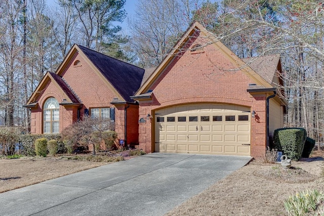 view of front of home with a garage, brick siding, and driveway