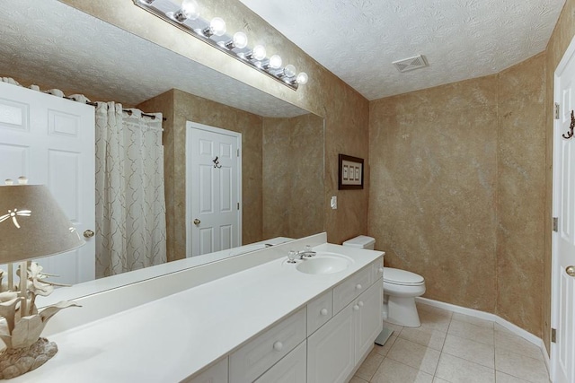 full bath with visible vents, toilet, tile patterned floors, a textured ceiling, and vanity