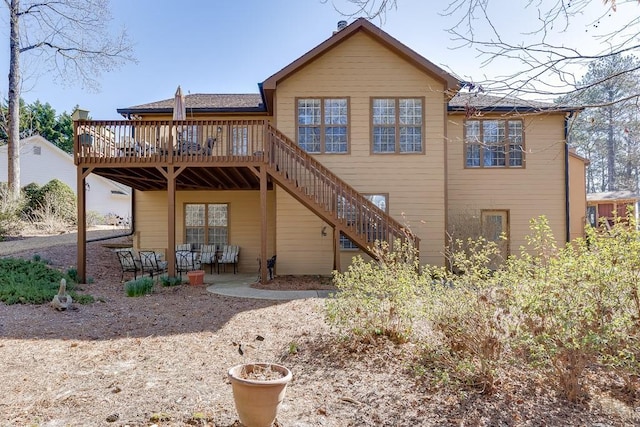 back of house with a deck and stairway