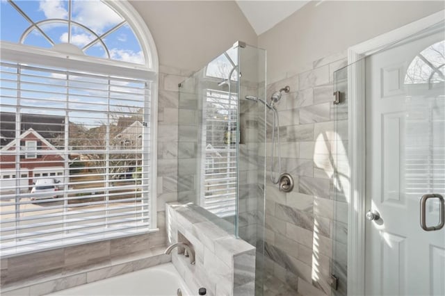 full bath featuring a shower stall, a garden tub, and lofted ceiling