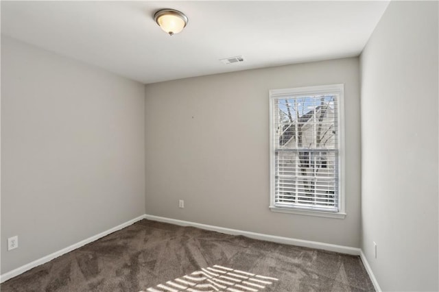 carpeted empty room featuring baseboards
