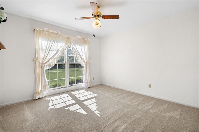 unfurnished room with carpet flooring, baseboards, and ceiling fan