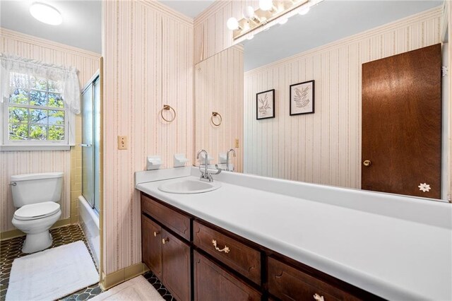 full bathroom with tile patterned floors, enclosed tub / shower combo, vanity, and toilet