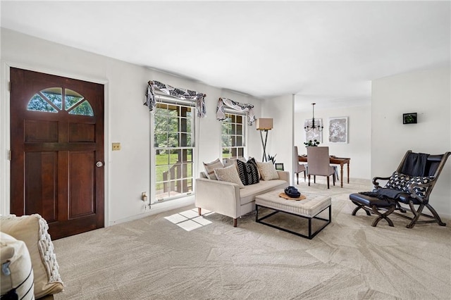carpeted living area with a chandelier