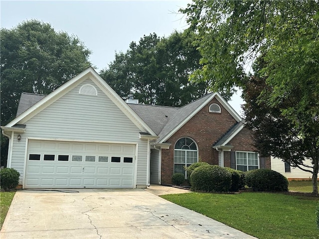3718 Jackson Bluff Dr, Lawrenceville, GA 30044 - view of front of property featuring concrete driveway, a garage, brick siding, and a front yard