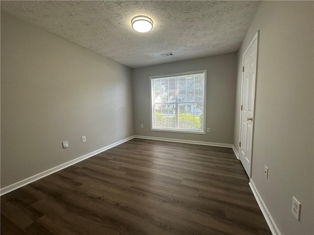 3718 Jackson Bluff Dr, Lawrenceville, GA 30044 - unfurnished room with dark wood-style flooring and a textured ceiling