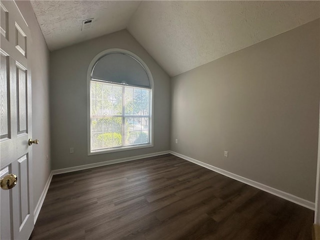 3718 Jackson Bluff Dr, Lawrenceville, GA 30044 - spare room featuring a textured ceiling, vaulted ceiling, and dark wood finished floors