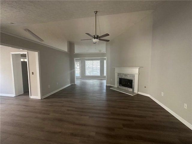 3718 Jackson Bluff Dr, Lawrenceville, GA 30044 - unfurnished living room with a ceiling fan, dark wood-type flooring, a fireplace, and lofted ceiling