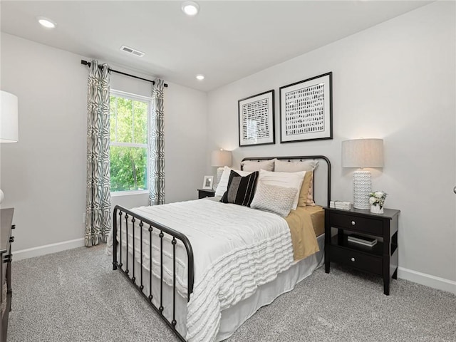 carpeted bedroom featuring baseboards, visible vents, and recessed lighting