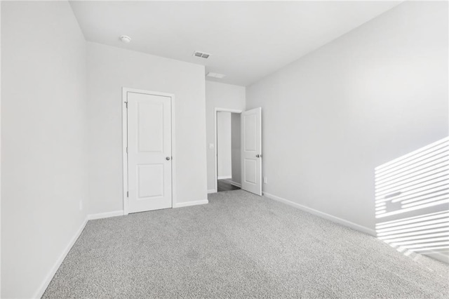unfurnished bedroom featuring baseboards, visible vents, and carpet floors