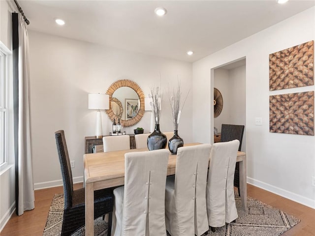 dining room featuring baseboards, recessed lighting, and wood finished floors