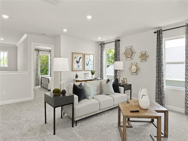 living room with plenty of natural light, visible vents, and baseboards