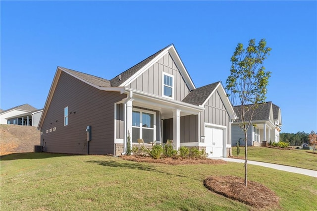 view of front of property with a front yard, a garage, and central air condition unit