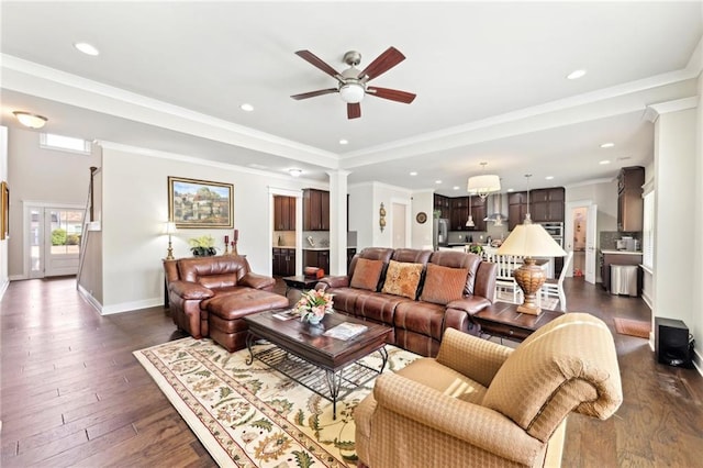 living room with dark wood-type flooring, baseboards, ceiling fan, ornamental molding, and recessed lighting