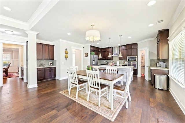 dining area with recessed lighting, decorative columns, and dark wood-style flooring