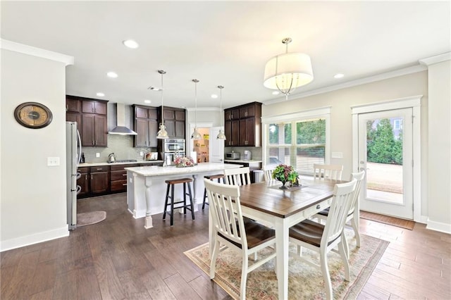 dining room with dark wood-type flooring, baseboards, and ornamental molding