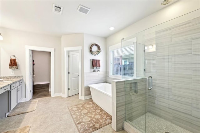 full bathroom with a bath, visible vents, a shower stall, and vanity