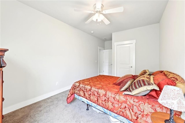 carpeted bedroom with baseboards and a ceiling fan