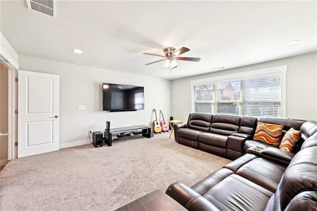 carpeted living area featuring visible vents, baseboards, and ceiling fan