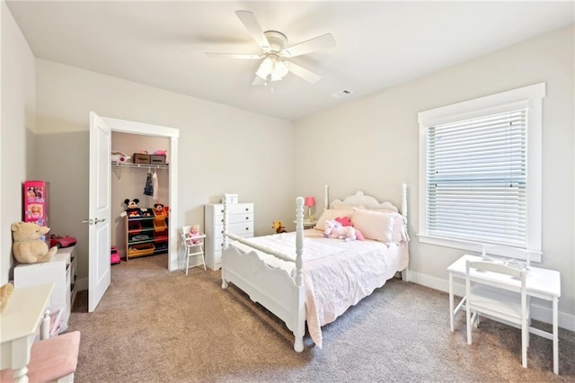 bedroom with baseboards, visible vents, ceiling fan, a closet, and light carpet