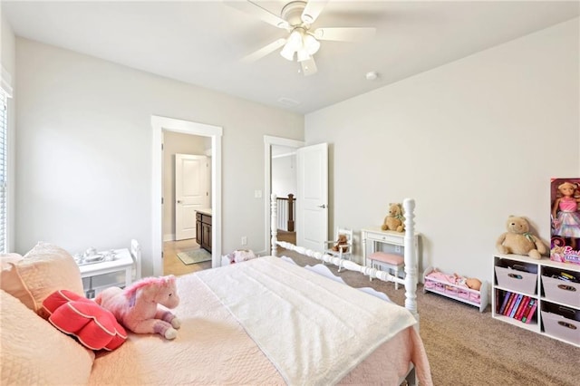 carpeted bedroom featuring a ceiling fan and ensuite bathroom