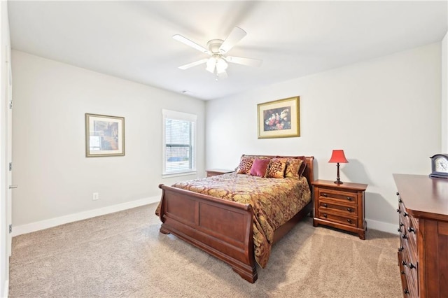 bedroom with a ceiling fan, baseboards, and light carpet