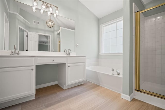 405 Sable Ct, Milton, GA 30004 - full bathroom featuring a bath, a shower stall, double vanity, wood finished floors, and vaulted ceiling