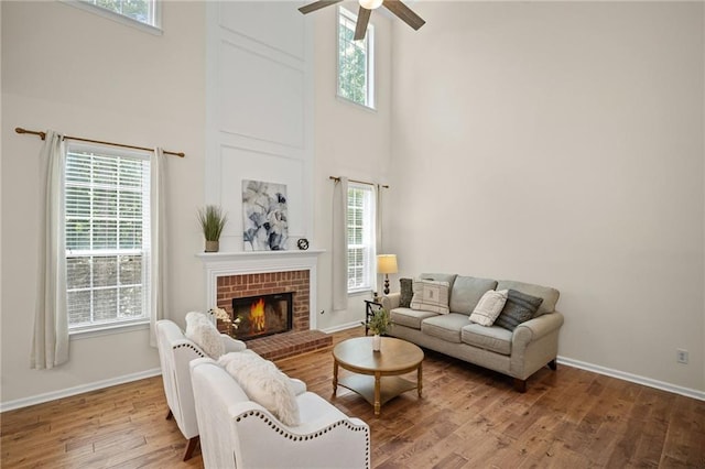 405 Sable Ct, Milton, GA 30004 - living area with a towering ceiling, a ceiling fan, wood finished floors, and a brick fireplace