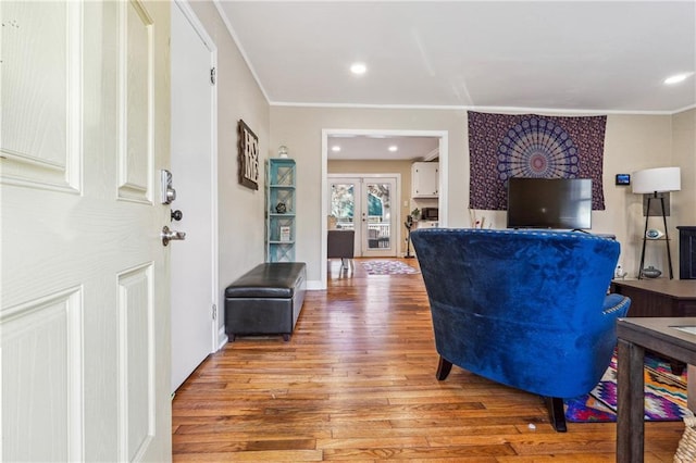 living room with recessed lighting, french doors, light wood-style flooring, and crown molding