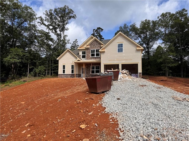 238 Lighthouse Cv SW, Adairsville, GA 30103 - rear view of property featuring stone siding, a garage, and gravel driveway