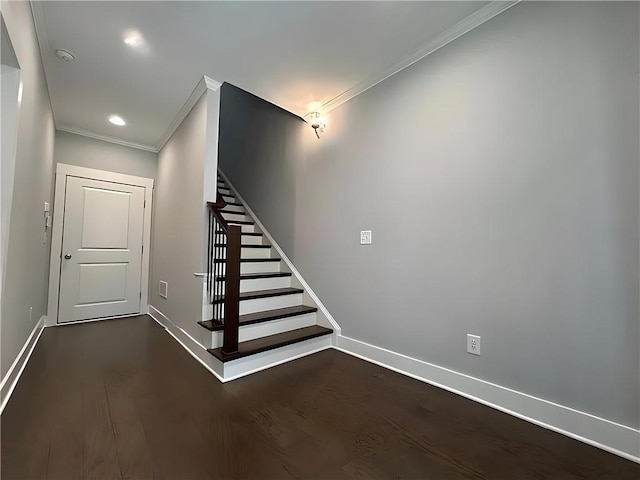 stairs with wood-type flooring and crown molding