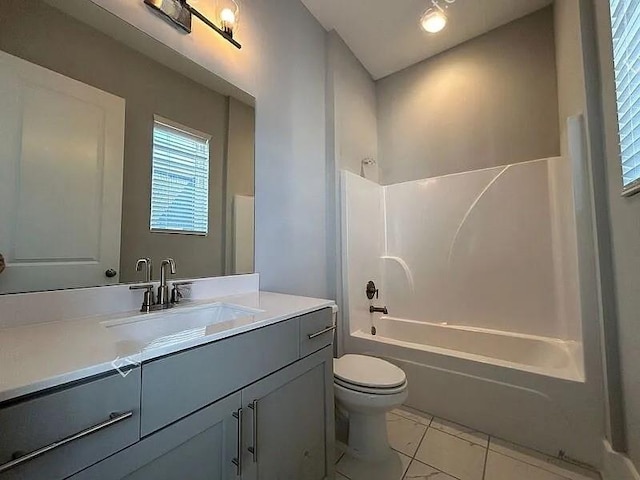 full bathroom with tile patterned floors, vanity, shower / bath combination, and toilet