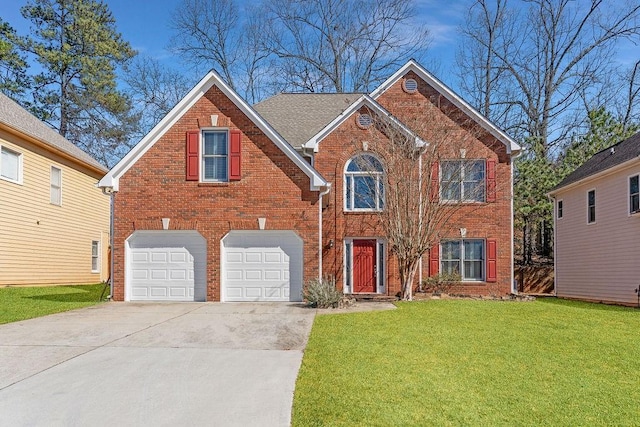 view of front of house featuring a garage, driveway, brick siding, and a front yard