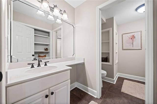 bathroom featuring tile patterned floors, vanity, and toilet