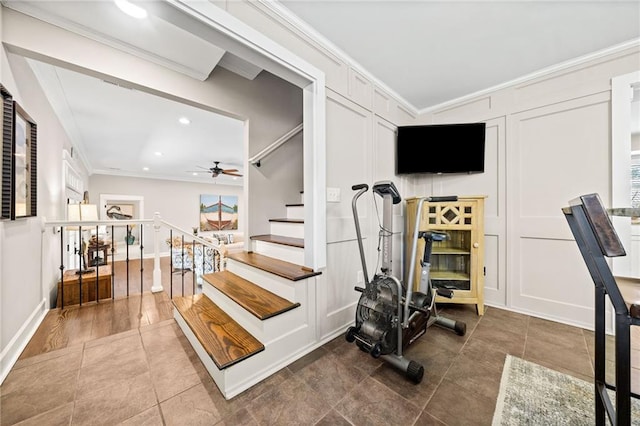 staircase with ceiling fan, crown molding, and tile patterned floors