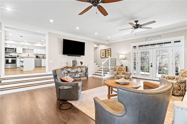 living room with french doors, light wood-type flooring, ceiling fan, and crown molding